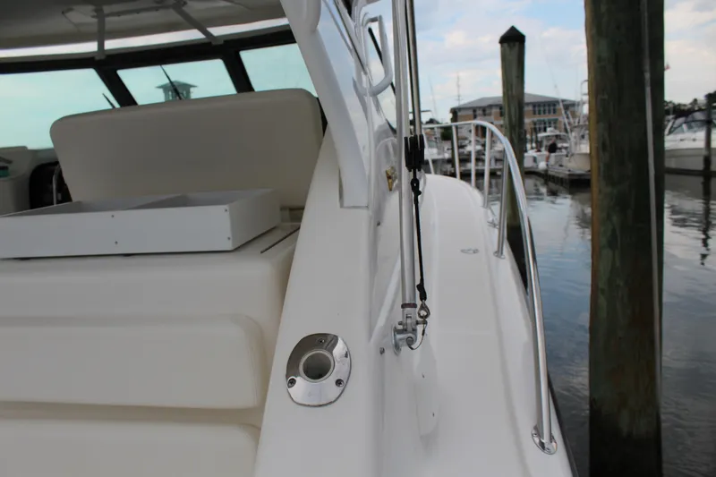 Slide: The Image of 2002 Tiara Yachts 3800 Open docked, showcasing sleek white exterior and marina background. - 34
