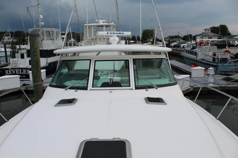 Slide: The Image of 2002 Tiara Yachts 3800 Open docked at a marina. - 38