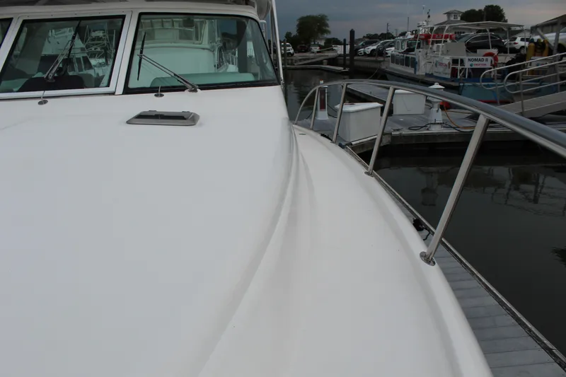 Slide: The Image of 2002 Tiara Yachts 3800 Open docked at a marina. - 39