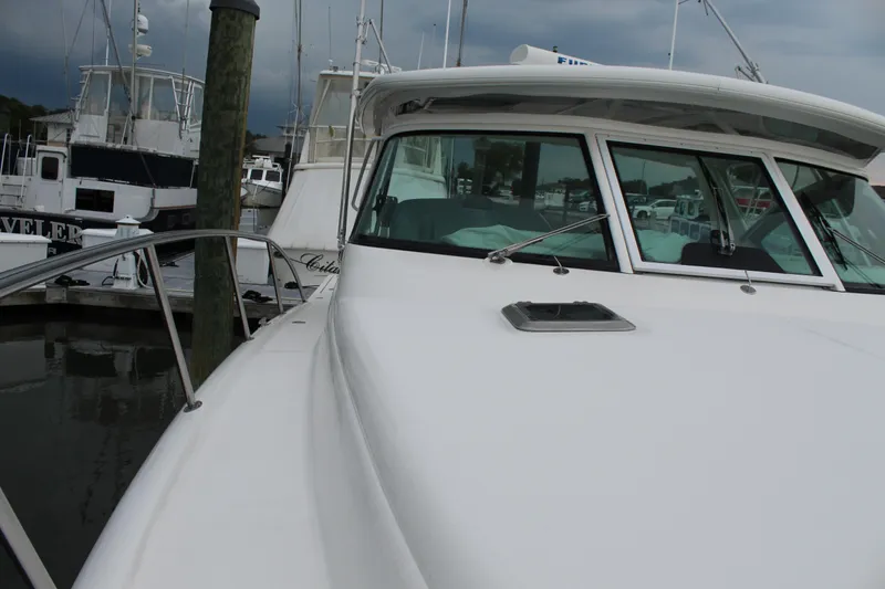 Slide: The Image of 2002 Tiara Yachts 3800 Open docked at a marina. - 41