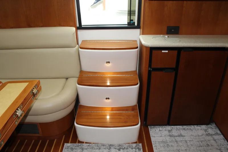 Slide: The Image of Interior of 2002 Tiara Yachts 3800 Open with wooden steps and seating. - 48