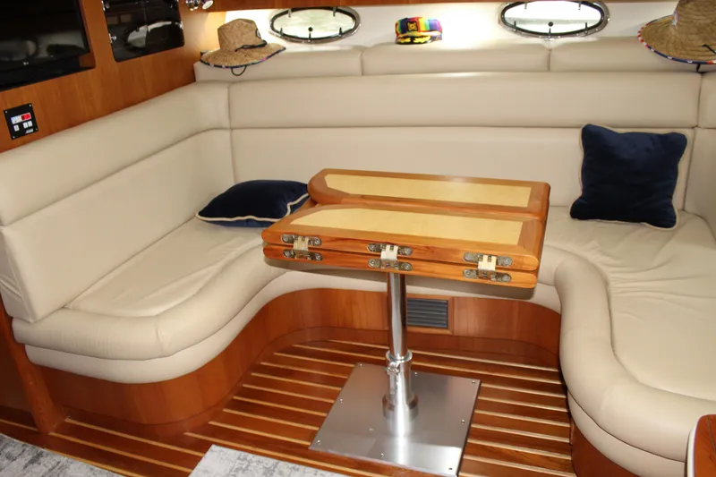 Slide: The Image of Luxurious interior of a 2002 Tiara Yachts 3800 Open with leather seating and wooden table. - 49
