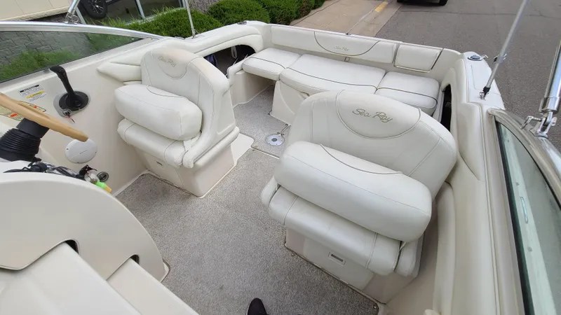 Slide: The Image of 2002 Sea Ray 225 Weekender boat interior with white leather seating. - 11