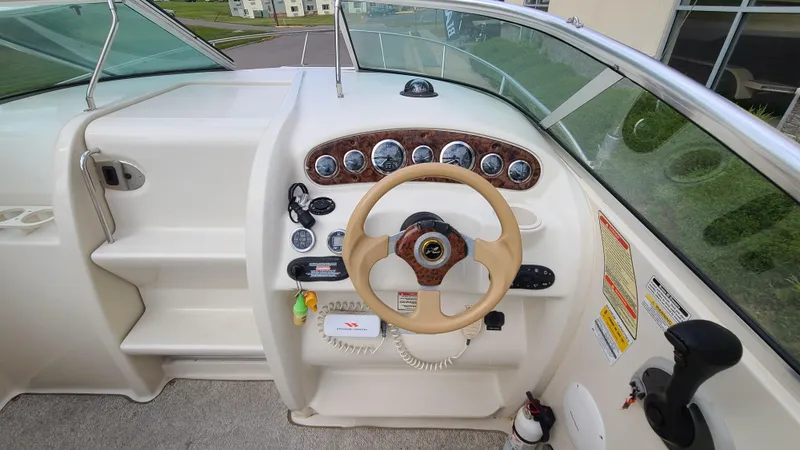 Slide: The Image of 2002 Sea Ray 225 Weekender boat helm with steering wheel and instrument panel. - 12