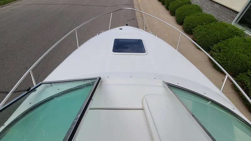 Slide: The Image of 2002 Sea Ray 225 Weekender boat bow view with open windshield. - 14