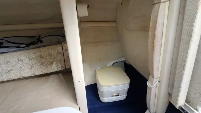 Slide: The Image of Interior cabin of a 2002 Sea Ray 225 Weekender boat with portable toilet. - 18