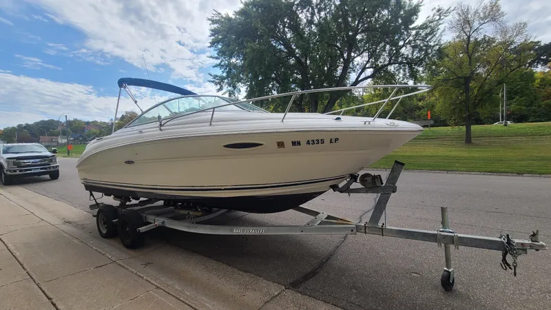 Slide: The Image of 2002 Sea Ray 225 Weekender boat on a trailer parked by the roadside. - 3