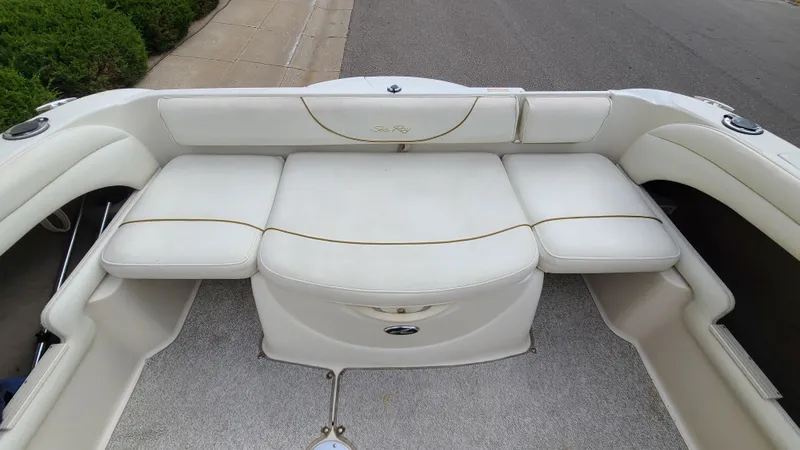 Slide: The Image of 2002 Sea Ray 225 Weekender boat with white cushioned seating. - 8