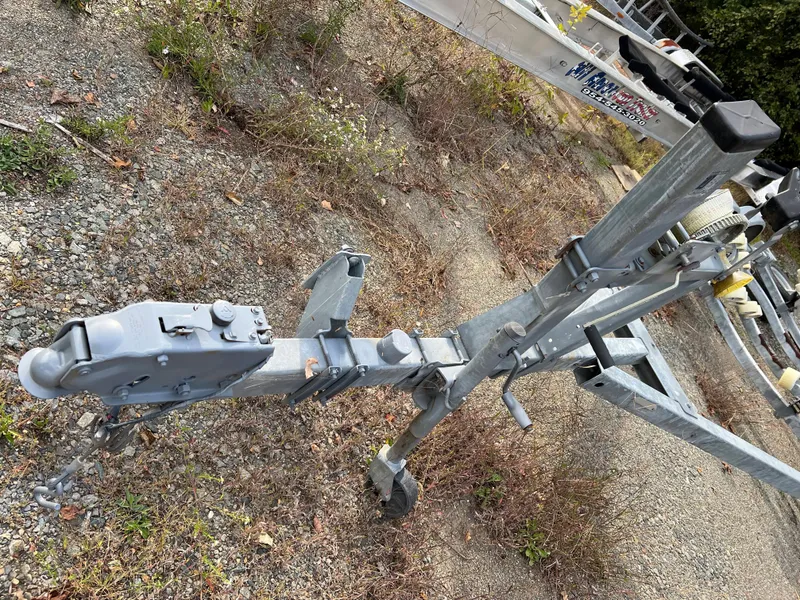 Slide: The Image of Trailer hitch for 1991 Sea Ray Sundancer 220 on gravel surface. - 13