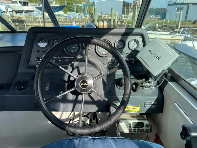 Slide: The Image of 1991 Sea Ray Sundancer 220 dashboard with steering wheel and Garmin GPS. - 5