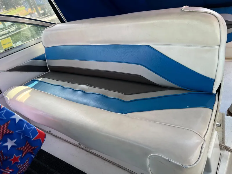 Slide: The Image of 1991 Sea Ray Sundancer 220 boat seat with blue and gray upholstery. - 7
