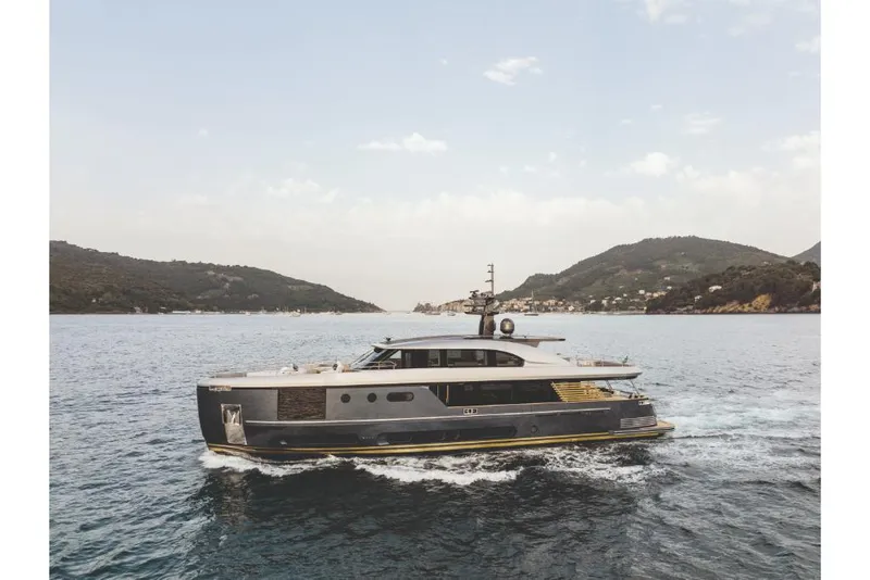 Slide: The Image of Azimut Magellano 30M 2023 yacht cruising in scenic coastal waters. - 12