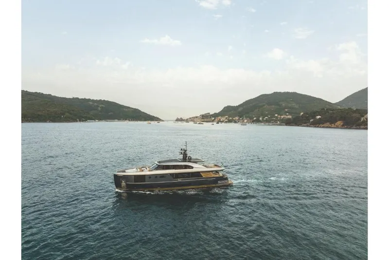 Slide: The Image of 2023 Azimut Magellano 30M yacht cruising in a scenic bay. - 13