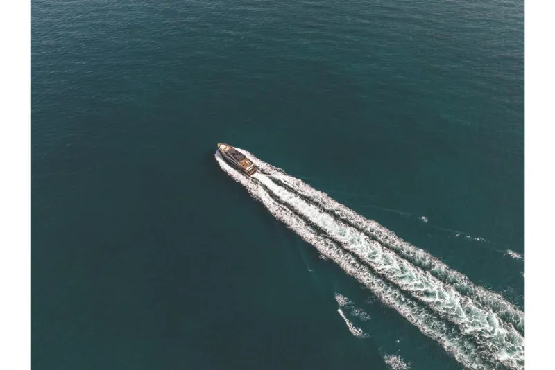 Slide: The Image of Aerial view of 2023 Azimut Magellano 30M yacht cruising on open water. - 14