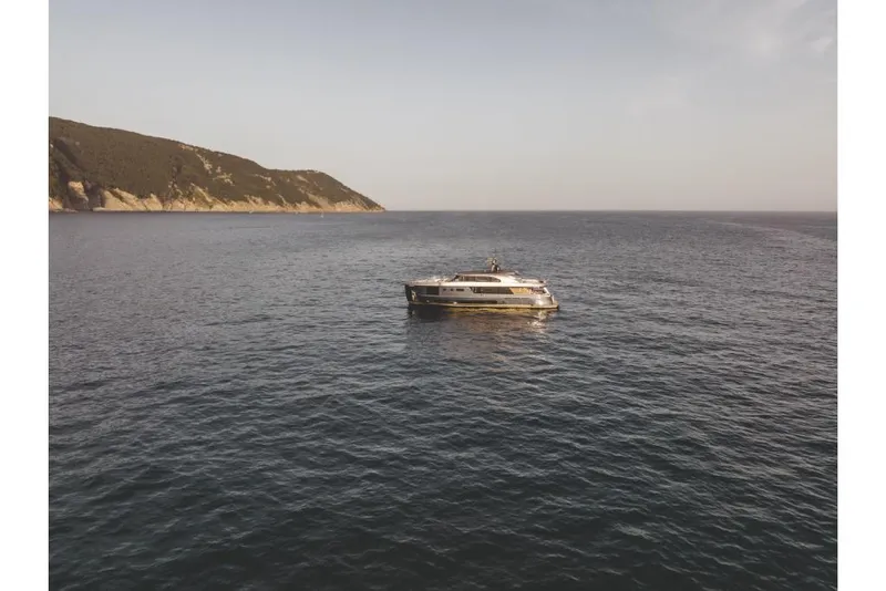 Slide: The Image of Azimut Magellano 30M 2023 yacht cruising on open sea near coastline. - 25