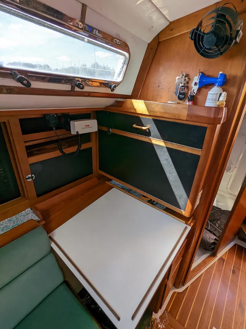 Slide: The Image of Cozy interior of a 1995 Freedom 40/40 sailboat with wooden cabinetry and seating. - 14