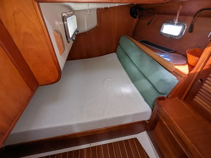 Slide: The Image of Cozy cabin interior of 1995 Freedom 40/40 sailboat with wooden finish and comfortable bedding. - 16