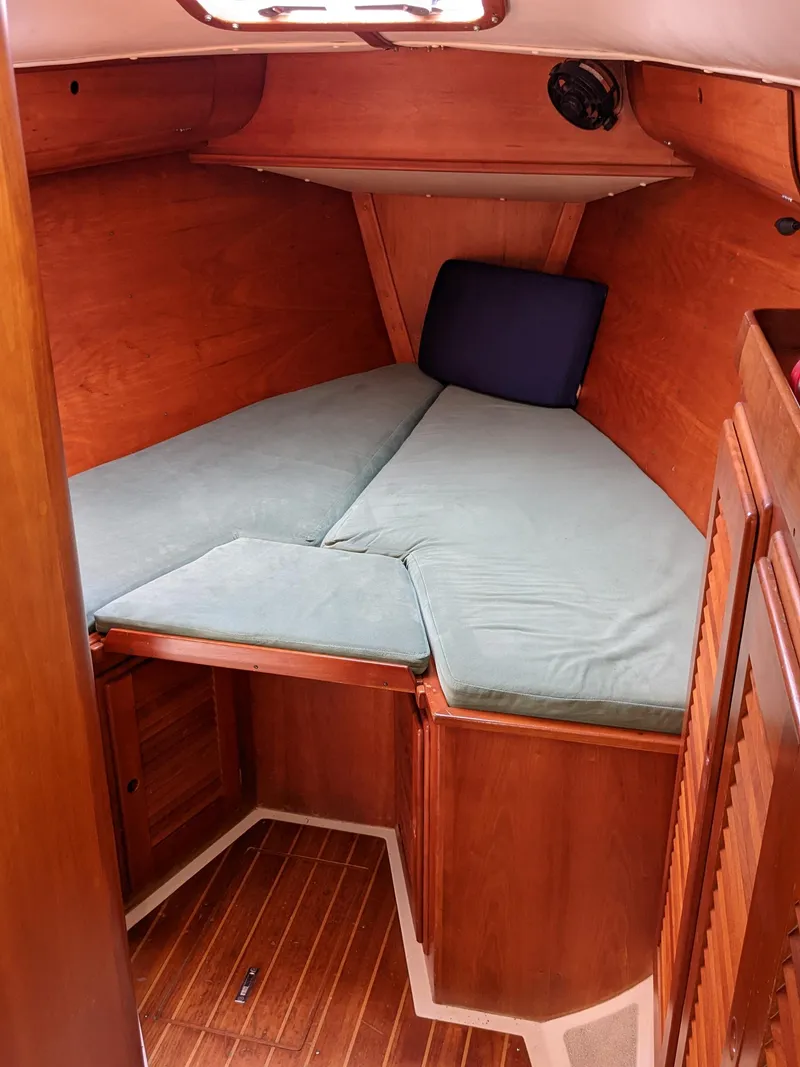 Slide: The Image of 1995 Freedom 40/40 sailboat cabin with wooden interior and V-berth. - 18