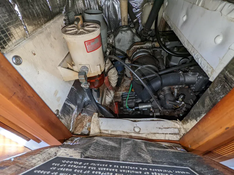 Slide: The Image of Engine compartment of a 1995 Freedom 40/40 sailboat, showing mechanical components and wiring. - 22