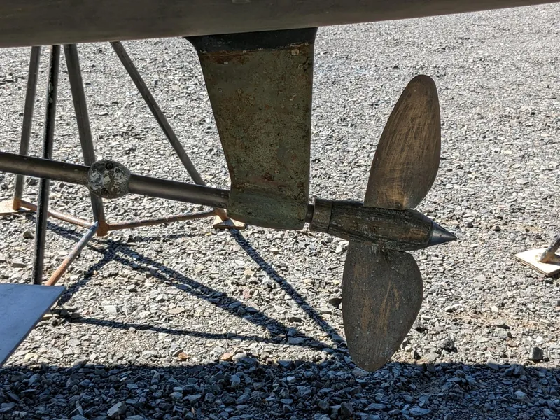 Slide: The Image of Propeller and rudder of a 1995 Freedom 40/40 boat on gravel surface. - 5
