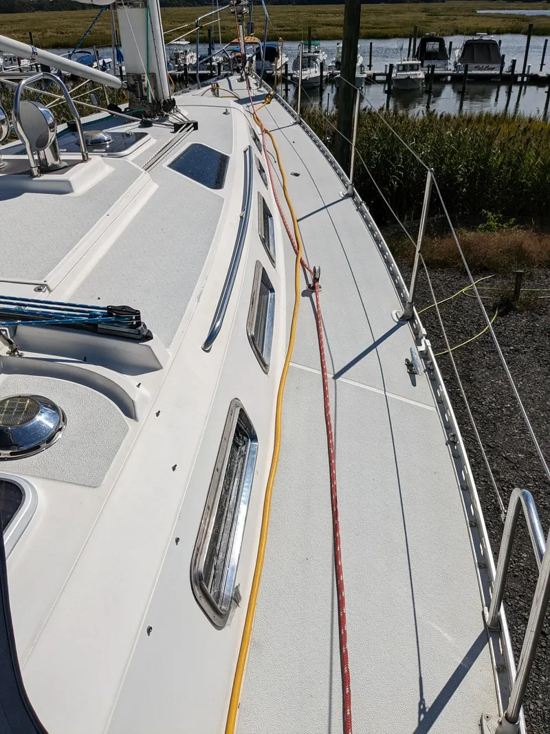 Slide: The Image of 1995 Freedom 40/40 sailboat deck with ropes and marina view. - 9