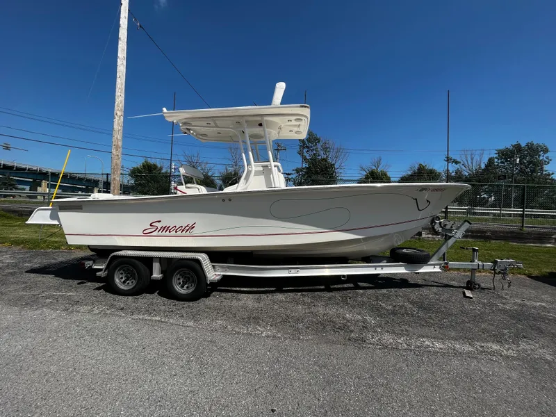 The Image of 2007 Silverhawk 24 CC boat on trailer under clear blue sky. - 1
