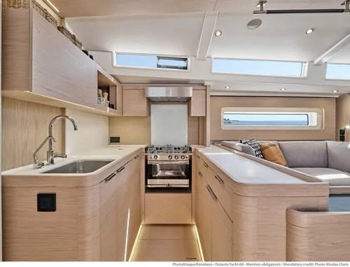 Slide: The Image of Luxurious interior of 2026 Beneteau Oceanis Yacht 60, featuring modern kitchen and seating area. - 13