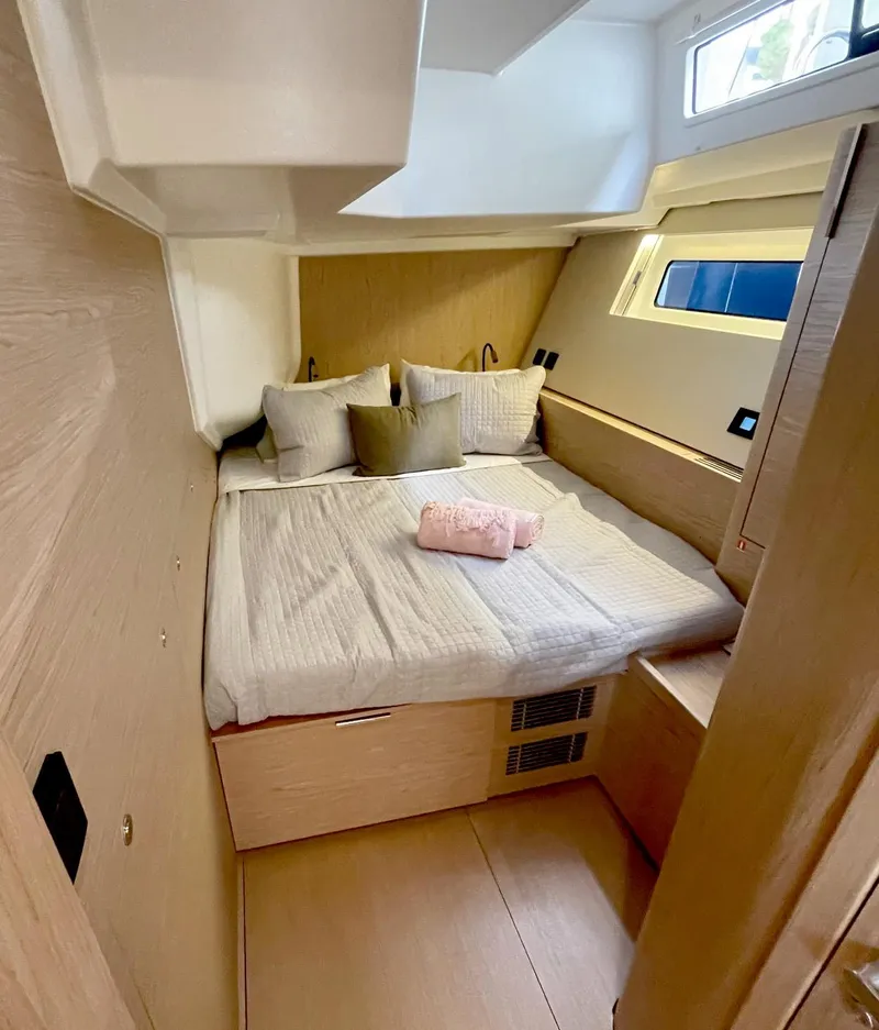 Slide: The Image of 2026 Beneteau Oceanis Yacht 60 cabin with cozy bed and modern design. - 16