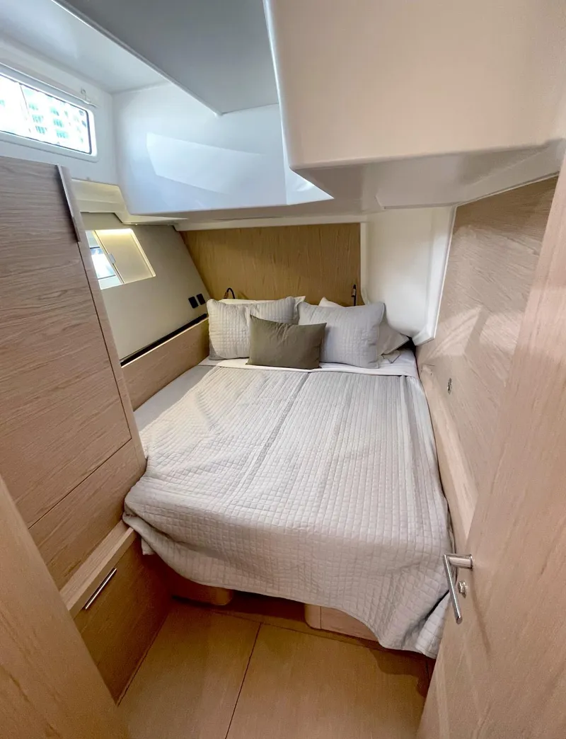 Slide: The Image of 2026 Beneteau Oceanis Yacht 60 cabin with cozy bed and modern design. - 17