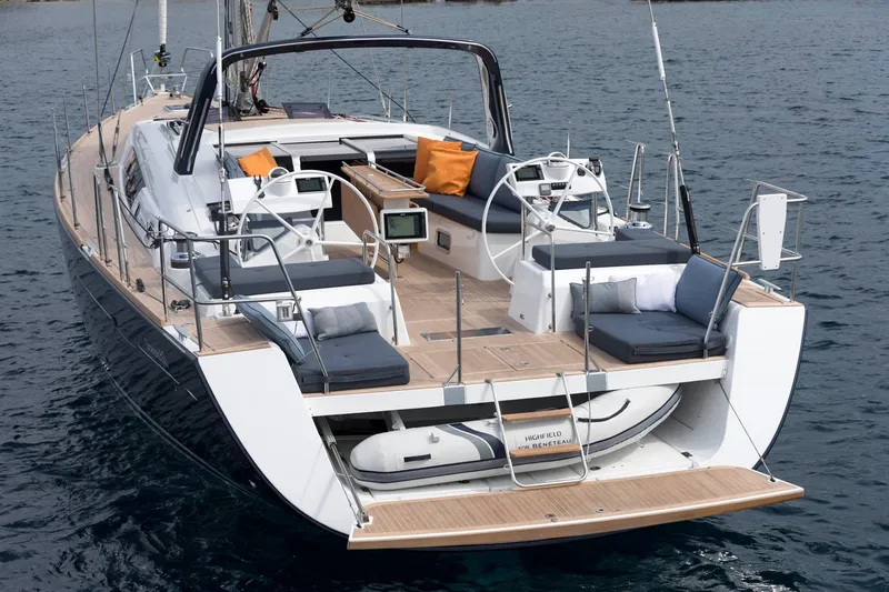 Slide: The Image of 2026 Beneteau Oceanis Yacht 60, luxurious deck view, anchored on calm waters. - 2