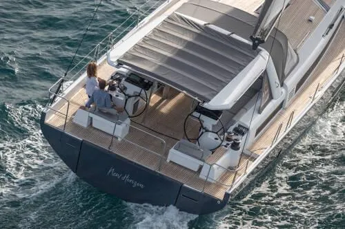 Slide: The Image of 2026 Beneteau Oceanis Yacht 60 sailing on open water, featuring spacious deck and dual helm. - 4