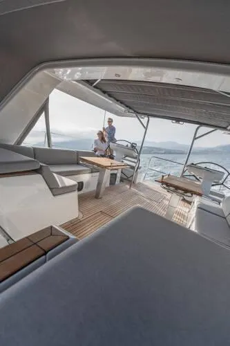 Slide: The Image of 2026 Beneteau Oceanis Yacht 60 interior with spacious seating and ocean view. - 6