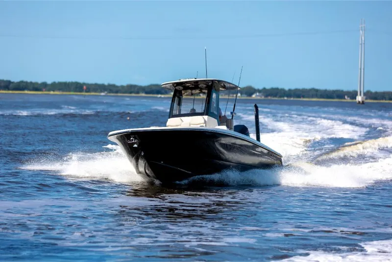 Slide: The Image of 2023 Scout 281 XSS boat cruising on open water. - 12