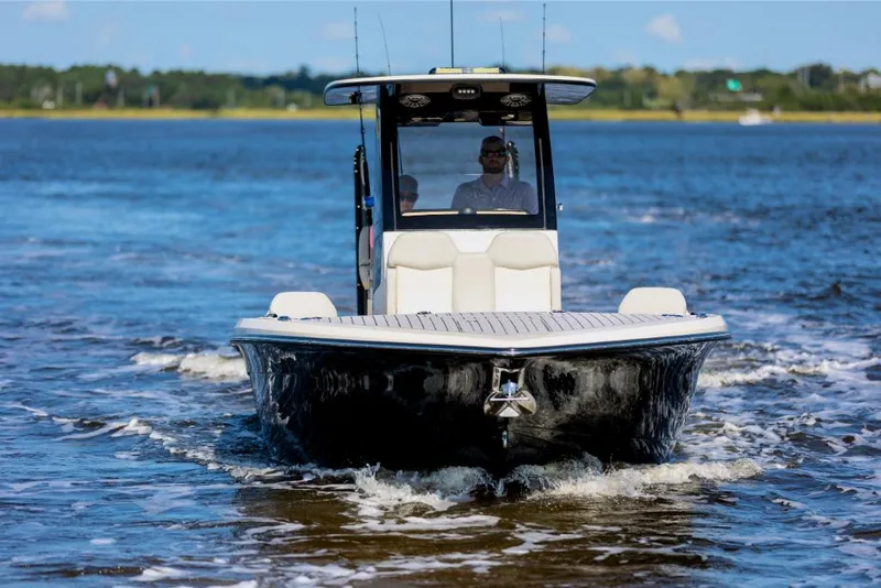 Slide: The Image of 2023 Scout 281 XSS boat cruising on open water. - 15