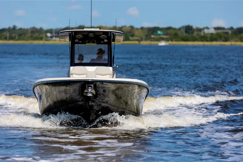 Slide: The Image of 2023 Scout 281 XSS boat cruising on open water. - 16