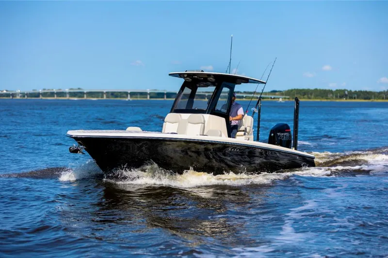 Slide: The Image of 2023 Scout 281 XSS boat cruising on open water. - 17