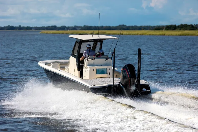 Slide: The Image of 2023 Scout 281 XSS boat cruising on a lake. - 20