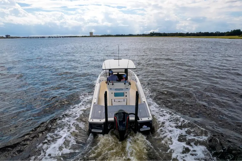 Slide: The Image of 2023 Scout 281 XSS boat cruising on open water. - 22