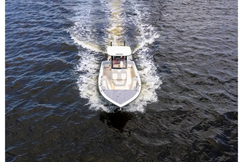 Slide: The Image of 2023 Scout 281 XSS boat cruising on open water. - 23