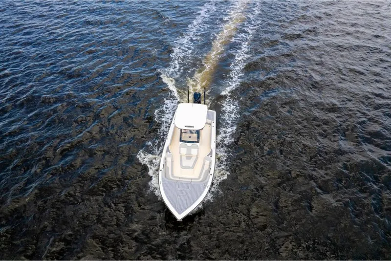 Slide: The Image of 2023 Scout 281 XSS boat cruising on open water. - 24