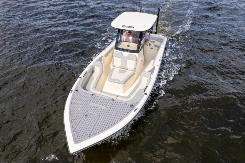 Slide: The Image of 2023 Scout 281 XSS boat cruising on water. - 27