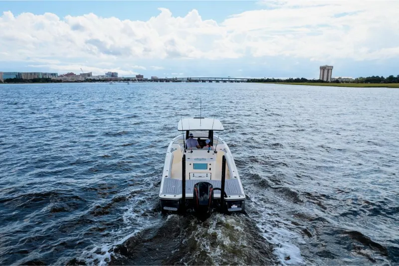 Slide: The Image of 2023 Scout 281 XSS boat cruising on open water. - 29