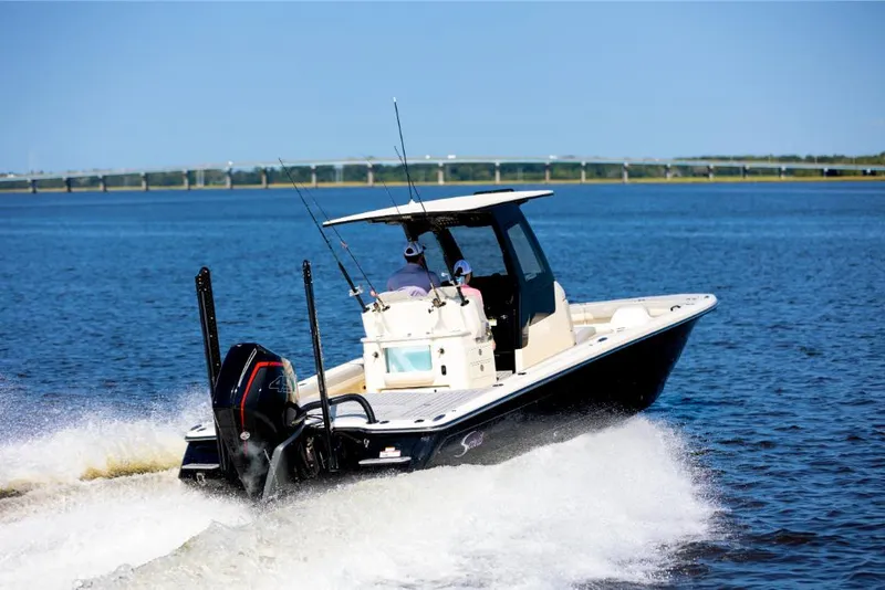 Slide: The Image of 2023 Scout 281 XSS boat cruising on open water. - 3