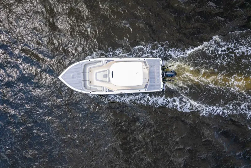 Slide: The Image of Aerial view of 2023 Scout 281 XSS boat cruising on water. - 30