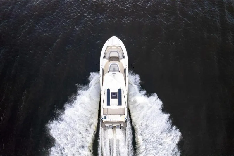 Slide: The Image of Aerial view of 2023 Scout 281 XSS boat cruising on water. - 32