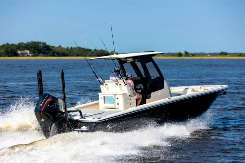 Slide: The Image of 2023 Scout 281 XSS boat cruising on a lake with fishing rods. - 4