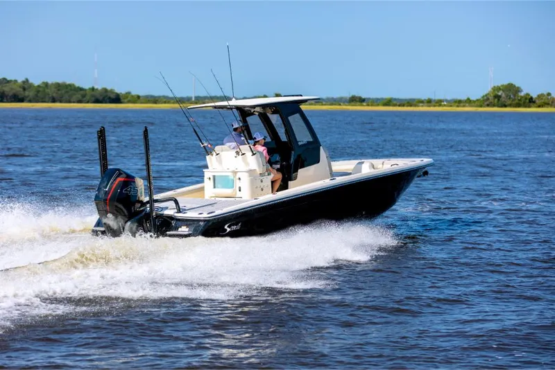 Slide: The Image of 2023 Scout 281 XSS boat cruising on a lake. - 5