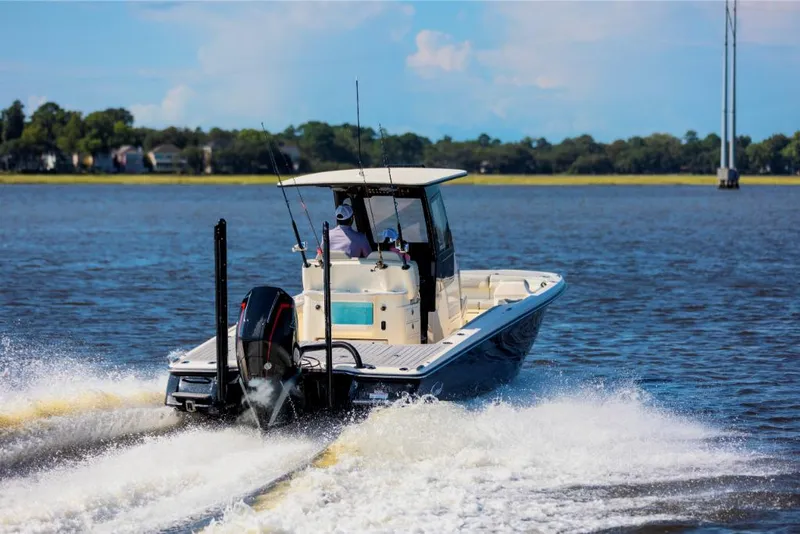 Slide: The Image of 2023 Scout 281 XSS boat cruising on a lake. - 8