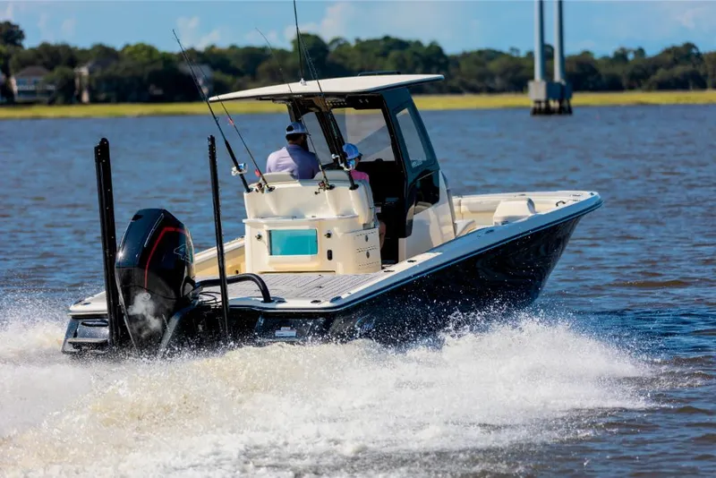 Slide: The Image of 2023 Scout 281 XSS boat cruising on a lake. - 9