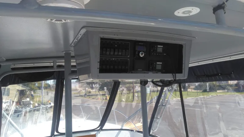 Slide: The Image of 1986 Blackfin 27 Cuddy boat dashboard with control panel and switches. - 2